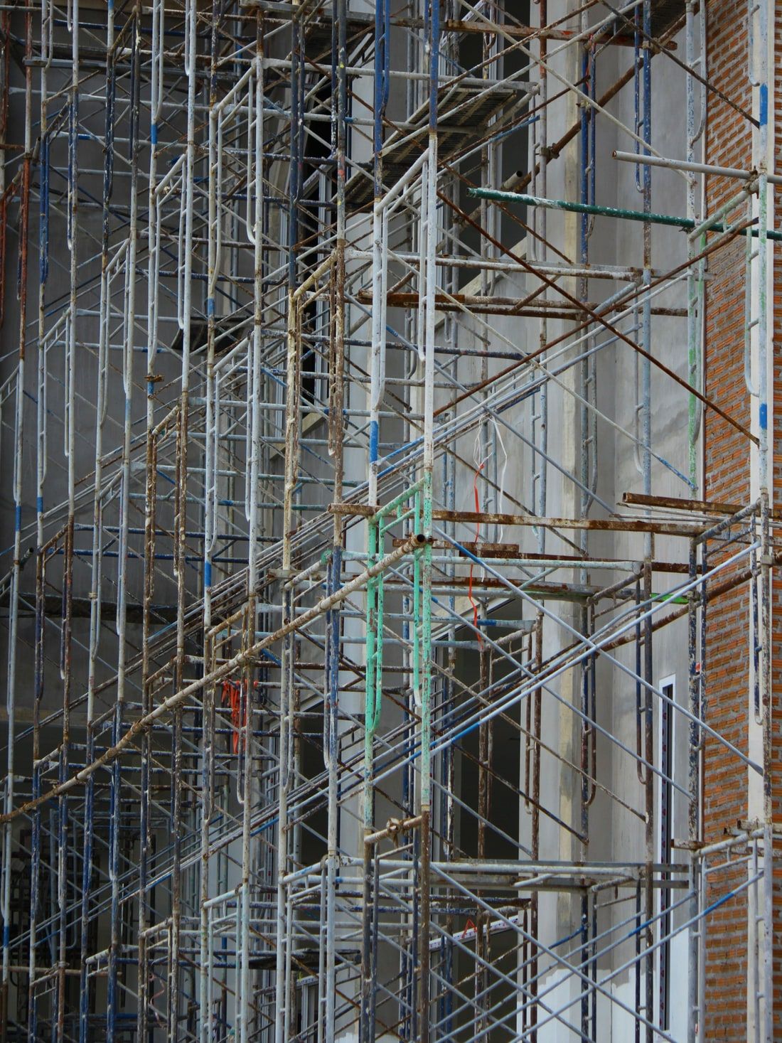 Dicht gestelltes Metallgerüst vor einer Fassade während der Bauarbeiten.